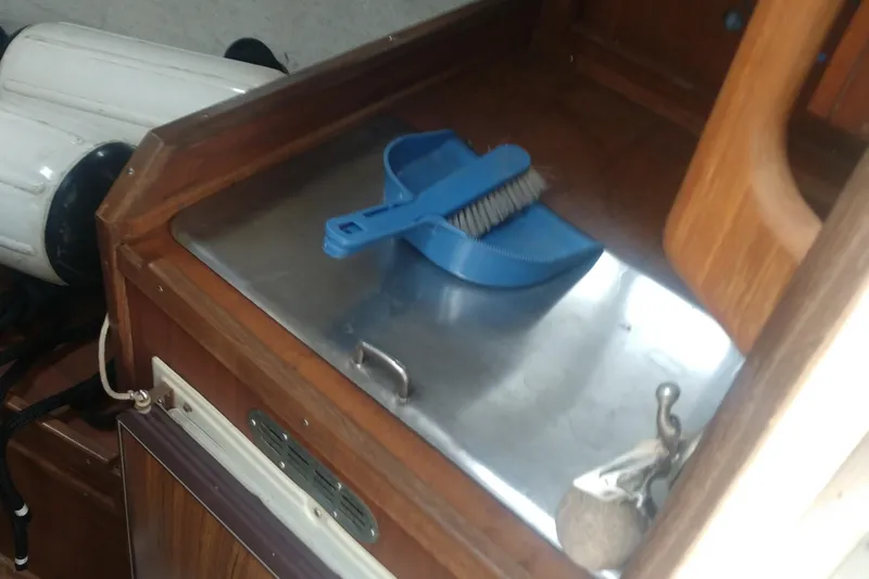 Slide: The Image of Interior of a 1978 Fortier 26 boat with cleaning tools. - 20