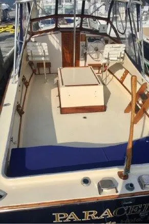 Slide: The Image of 1978 Fortier 26 boat with open deck and wooden features. - 3
