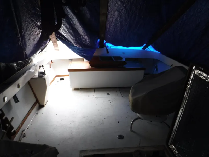 Slide: The Image of Interior of a 1978 Fortier 26 boat with tarp cover. - 7
