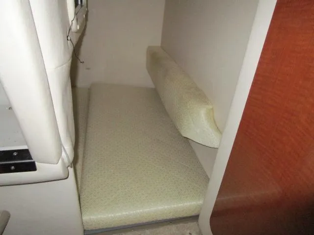 Slide: The Image of 2004 Sea Ray 260 Sundancer cabin interior with cushioned seating area. - 11