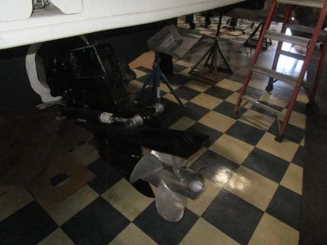 Slide: The Image of 2004 Sea Ray 260 Sundancer boat propeller on checkered floor, with ladder and stands nearby. - 18
