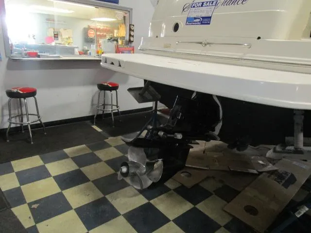Slide: The Image of 2004 Sea Ray 260 Sundancer boat in showroom with checkered floor and bar stools. - 19