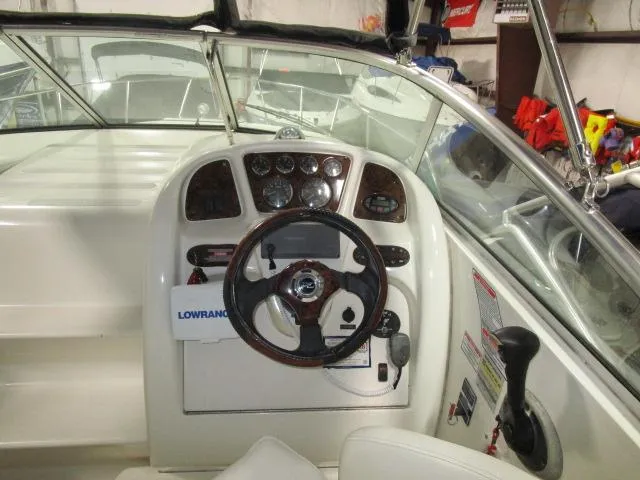 Slide: The Image of 2004 Sea Ray 260 Sundancer boat helm with steering wheel and instrument panel. - 5