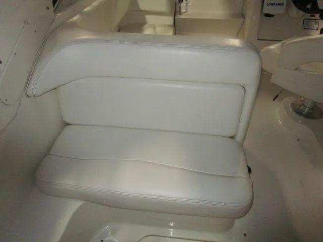 Slide: The Image of 2004 Sea Ray 260 Sundancer interior with white cushioned seating. - 8