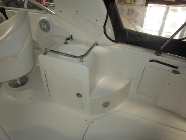 Slide: The Image of 2004 Sea Ray 260 Sundancer interior with sink and storage compartments. - 9