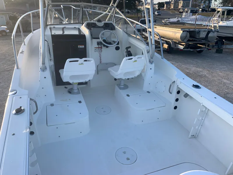 Slide: The Image of 2003 Aquasport 225 Explorer boat interior with dual seats and steering console. - 14