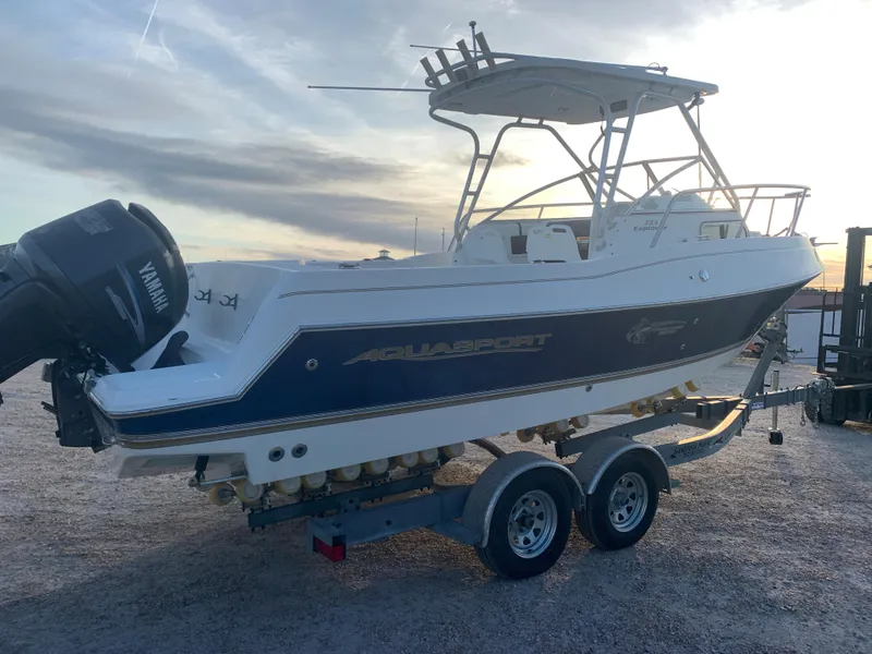 Slide: The Image of 2003 Aquasport 225 Explorer boat on a trailer with Yamaha outboard motor. - 2