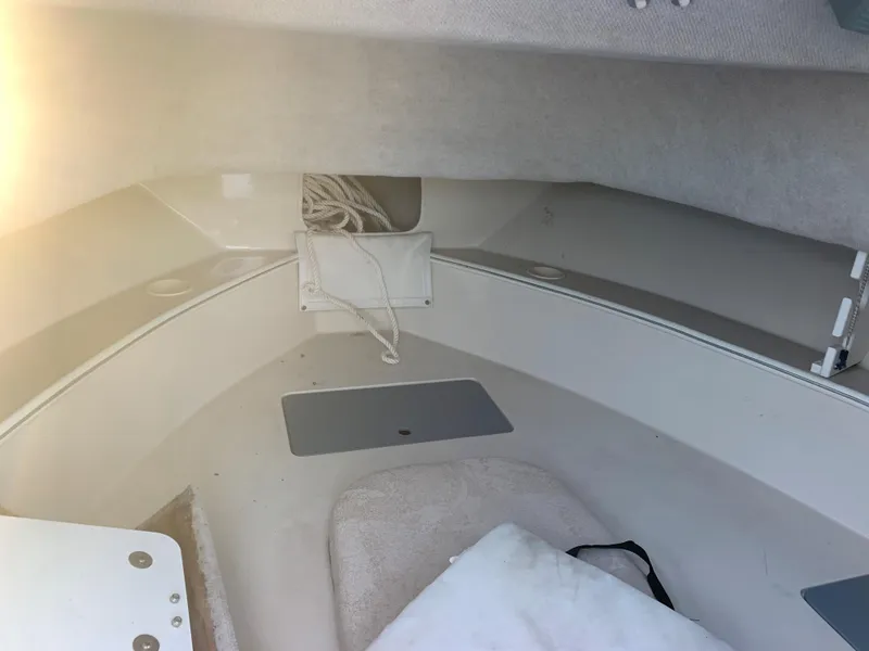 Slide: The Image of Interior of 2003 Aquasport 225 Explorer boat showing storage and seating area. - 22