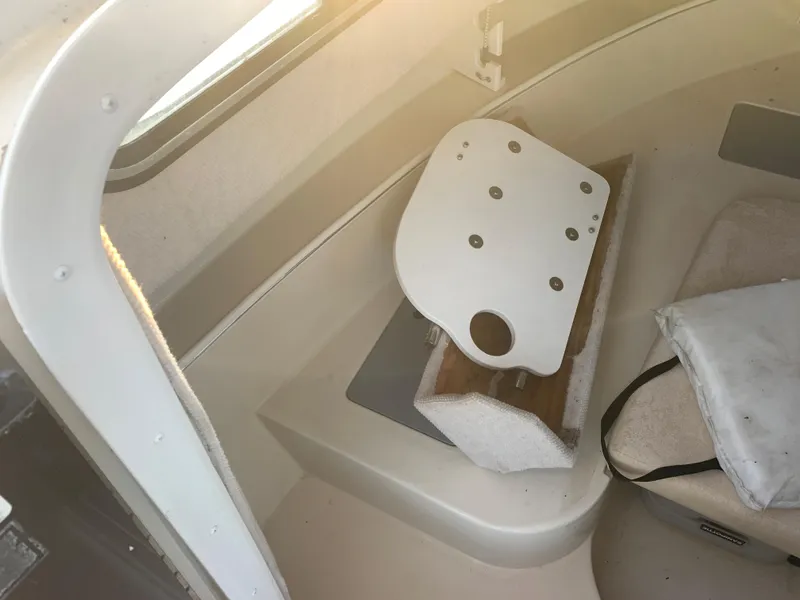 Slide: The Image of Interior of a 2003 Aquasport 225 Explorer boat showing seating and storage area. - 24