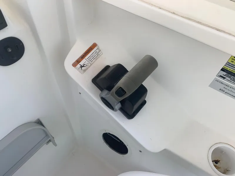 Slide: The Image of Close-up of the throttle control on a 2003 Aquasport 225 Explorer boat. - 26