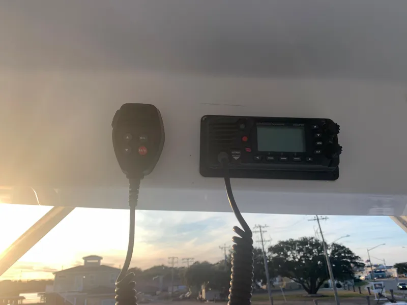 Slide: The Image of VHF radio and microphone on a 2003 Aquasport 225 Explorer boat. - 28