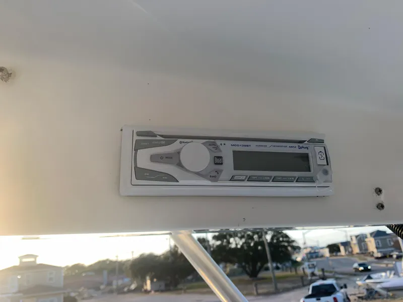 Slide: The Image of Close-up of the control panel on a 2003 Aquasport 225 Explorer boat. - 29