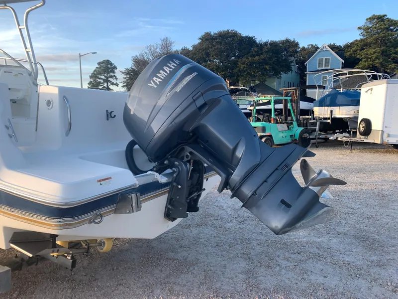 Slide: The Image of 2003 Aquasport 225 Explorer with Yamaha outboard motor in a boatyard. - 4