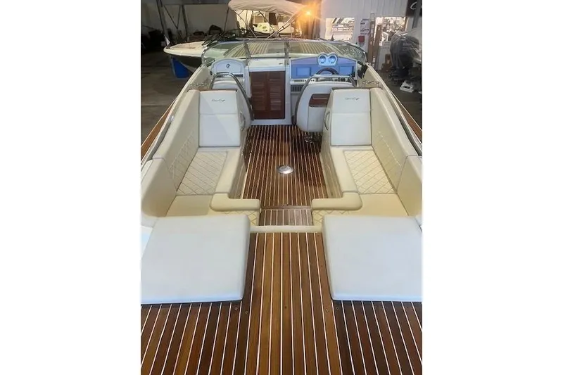 Slide: The Image of 2021 Chris-Craft Corsair 34 interior with luxurious seating and wooden flooring. - 10