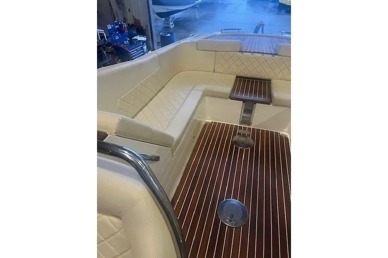 Slide: The Image of 2021 Chris-Craft Corsair 34 interior with elegant seating and wooden flooring. - 11