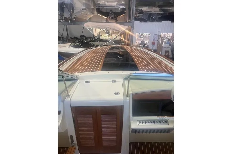 Slide: The Image of 2021 Chris-Craft Corsair 34 boat interior with wood accents and control panel. - 14