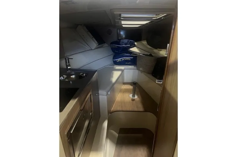 Slide: The Image of 2021 Chris-Craft Corsair 34 cabin interior with kitchenette and seating area. - 18