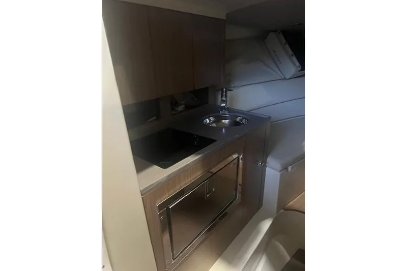 Slide: The Image of 2021 Chris-Craft Corsair 34 interior kitchen with sink and cabinetry. - 19