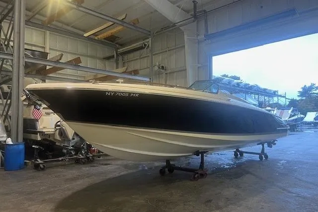 Slide: The Image of 2021 Chris-Craft Corsair 34 boat in a storage facility, side view. - 2