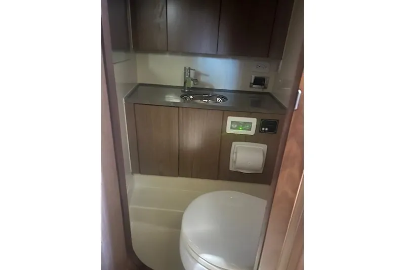 Slide: The Image of 2021 Chris-Craft Corsair 34 bathroom interior with sink and storage cabinets. - 21