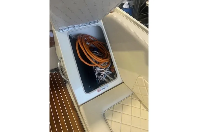 Slide: The Image of Storage compartment in 2021 Chris-Craft Corsair 34 boat with coiled cables inside. - 22