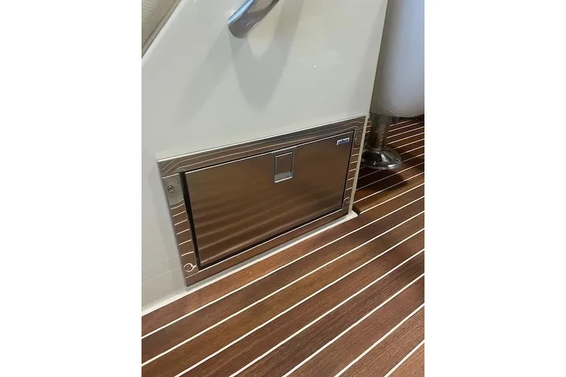 Slide: The Image of 2021 Chris-Craft Corsair 34 interior with stainless steel compartment and wooden flooring. - 24