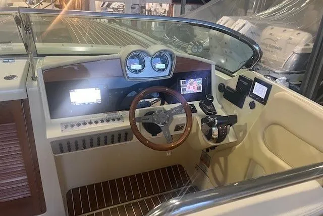 Slide: The Image of 2021 Chris-Craft Corsair 34 cockpit with modern controls and wooden steering wheel. - 25