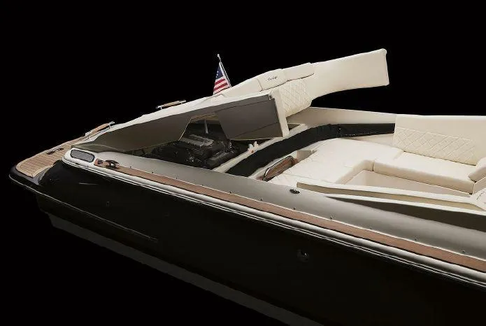 Slide: The Image of 2021 Chris-Craft Corsair 34 boat with elegant design and American flag, side view. - 28