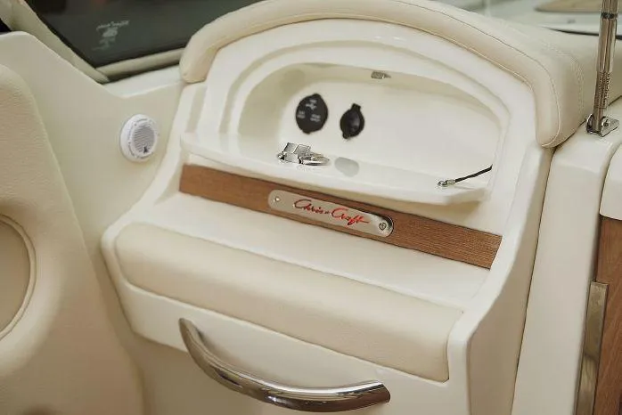 Slide: The Image of 2021 Chris-Craft Corsair 34 interior detail with beige upholstery and branded emblem. - 32
