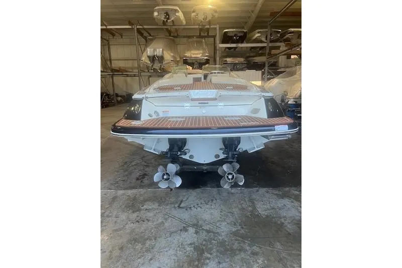 Slide: The Image of 2021 Chris-Craft Corsair 34 boat in storage, rear view showing dual propellers. - 4