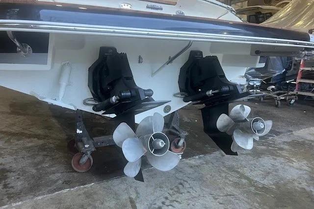 Slide: The Image of 2021 Chris-Craft Corsair 34 boat with dual propellers in a garage setting. - 5