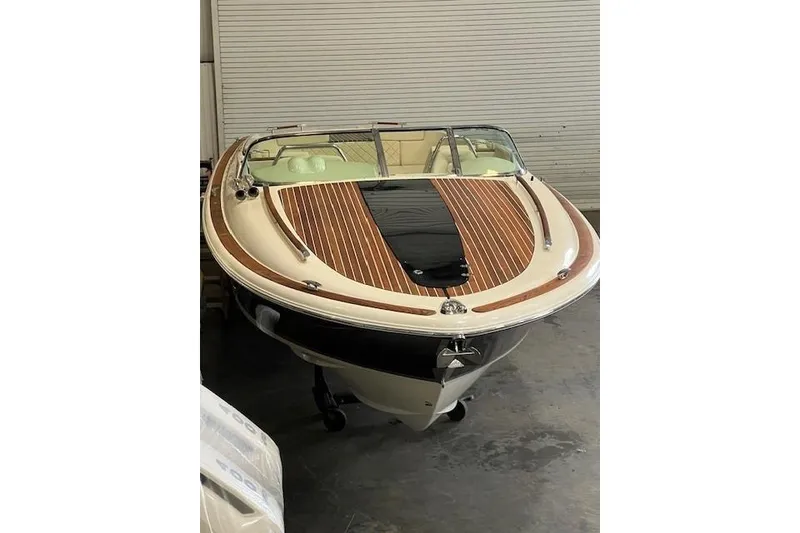 Slide: The Image of 2021 Chris-Craft Corsair 34 boat with elegant wood detailing in a garage setting. - 8