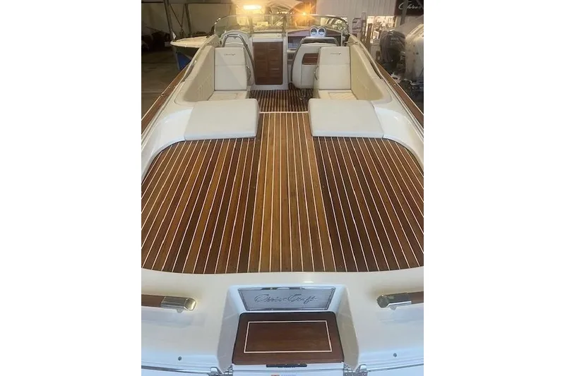 Slide: The Image of 2021 Chris-Craft Corsair 34 boat with elegant wooden deck and white seating. - 9