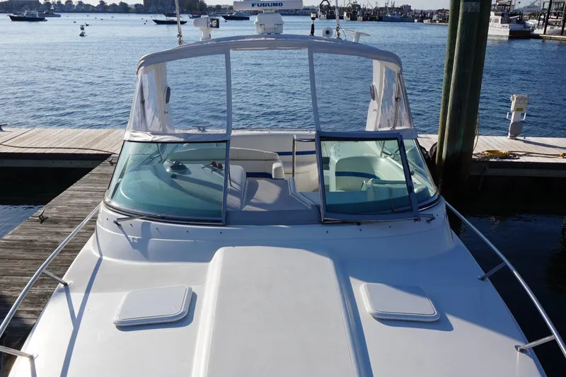 Slide: The Image of 2002 Formula 370 Super Sport boat interior with seating and table, docked at marina. - 10