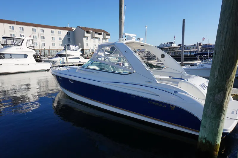 Slide: The Image of 2002 Formula 370 Super Sport boat cruising on a sunny day in a scenic bay. - 3
