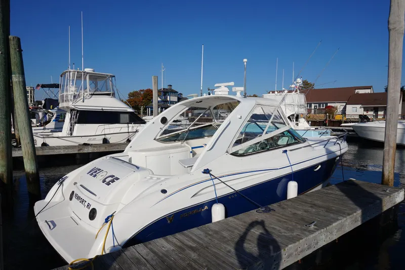 Slide: The Image of 2002 Formula 370 Super Sport yacht on calm water under clear blue sky. - 4