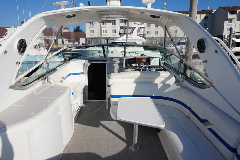 Slide: The Image of 2002 Formula 370 Super Sport boat on calm water under clear blue sky. - 5