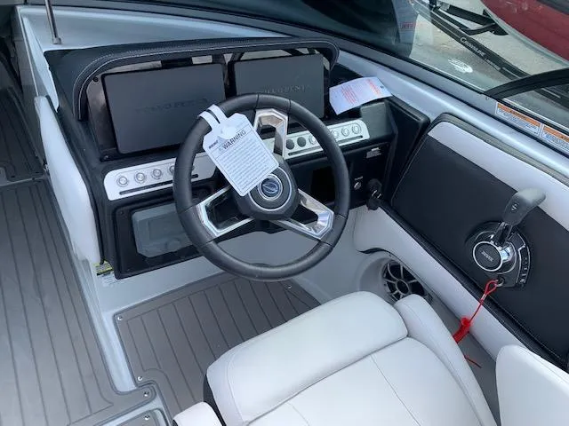 Slide: The Image of 2022 Crownline 255 SS boat cockpit with steering wheel and control panel. - 4