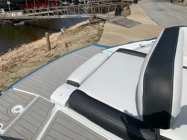 Slide: The Image of 2022 Crownline 255 SS boat with comfortable seating near a dock. - 7