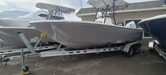 The Image of 2023 Sea Born LX22 Center Console boat on trailer, parked outdoors. - 0