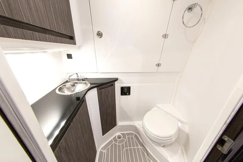 Slide: The Image of Modern bathroom in 2025 Cigarette 42 Auroris boat with sink, toilet, and storage cabinets. - 11