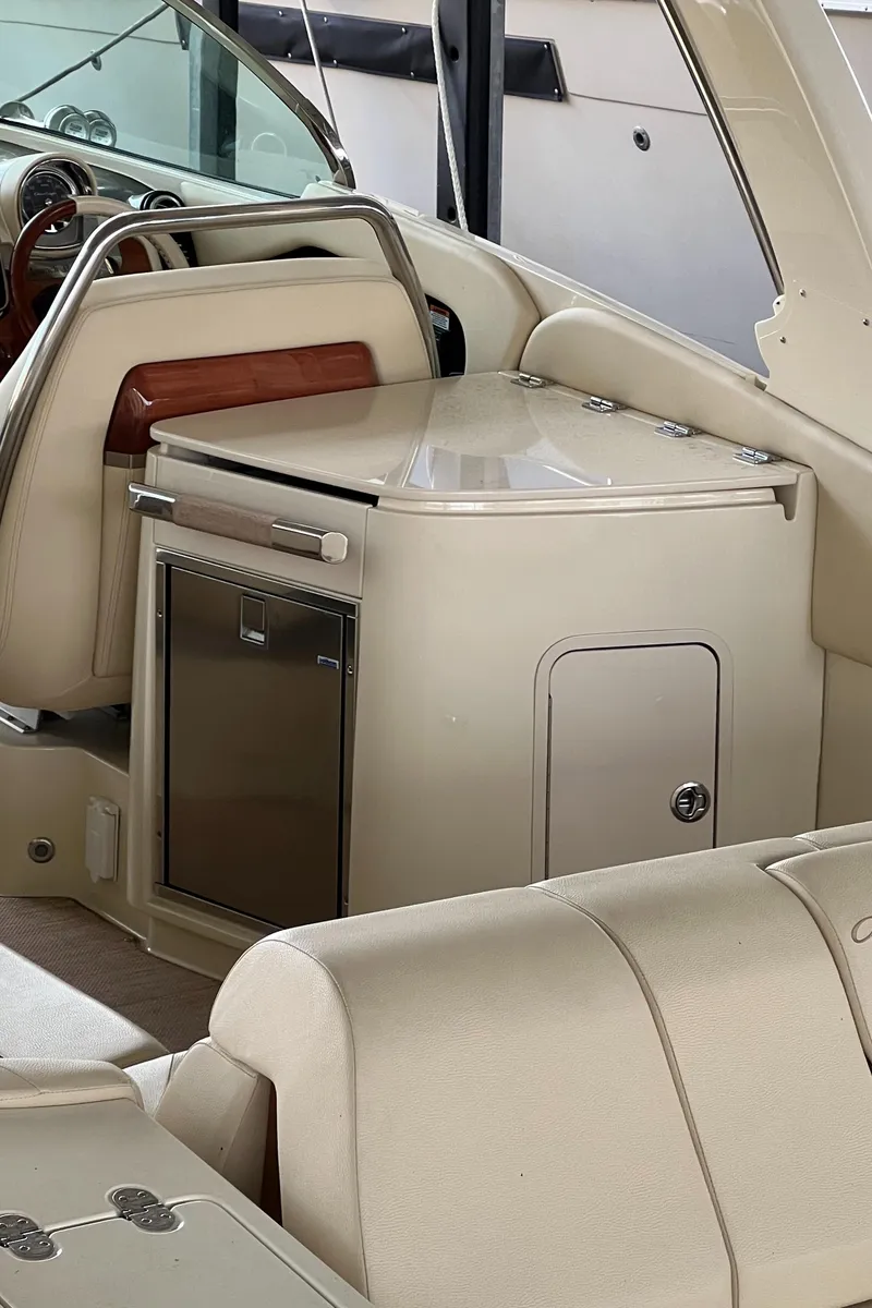 Slide: The Image of 2020 Chris-Craft Launch 31 GT interior with beige leather seating and compact kitchenette. - 11