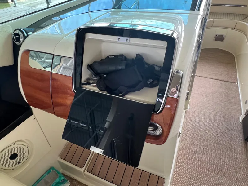 Slide: The Image of 2020 Chris-Craft Launch 31 GT interior storage compartment with binoculars and life jacket. - 18