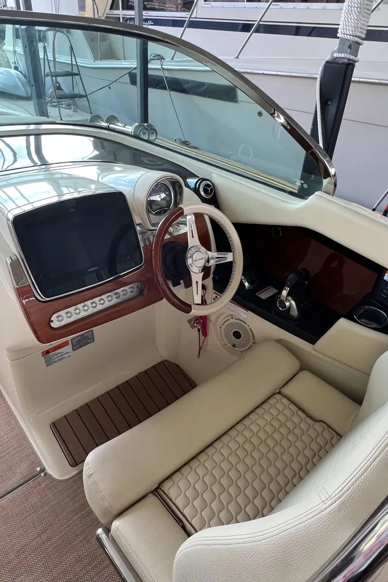 Slide: The Image of 2020 Chris-Craft Launch 31 GT boat cockpit with steering wheel and control panel. - 20