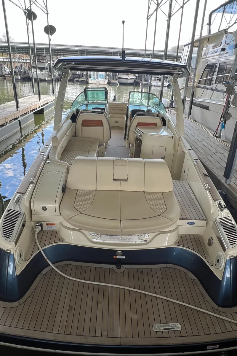 Slide: The Image of 2020 Chris-Craft Launch 31 GT luxury boat docked, showcasing spacious seating and elegant design. - 32