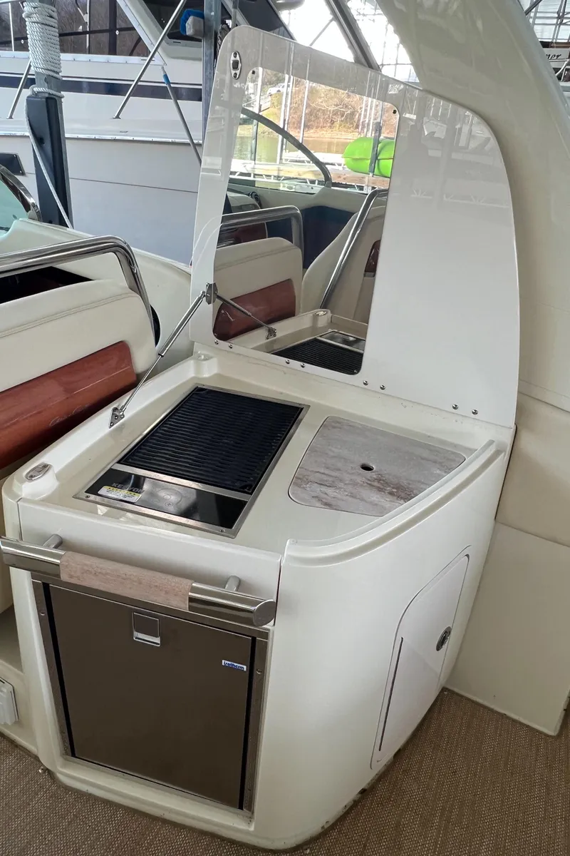 Slide: The Image of 2020 Chris-Craft Launch 31 GT boat interior with kitchenette and seating. - 33