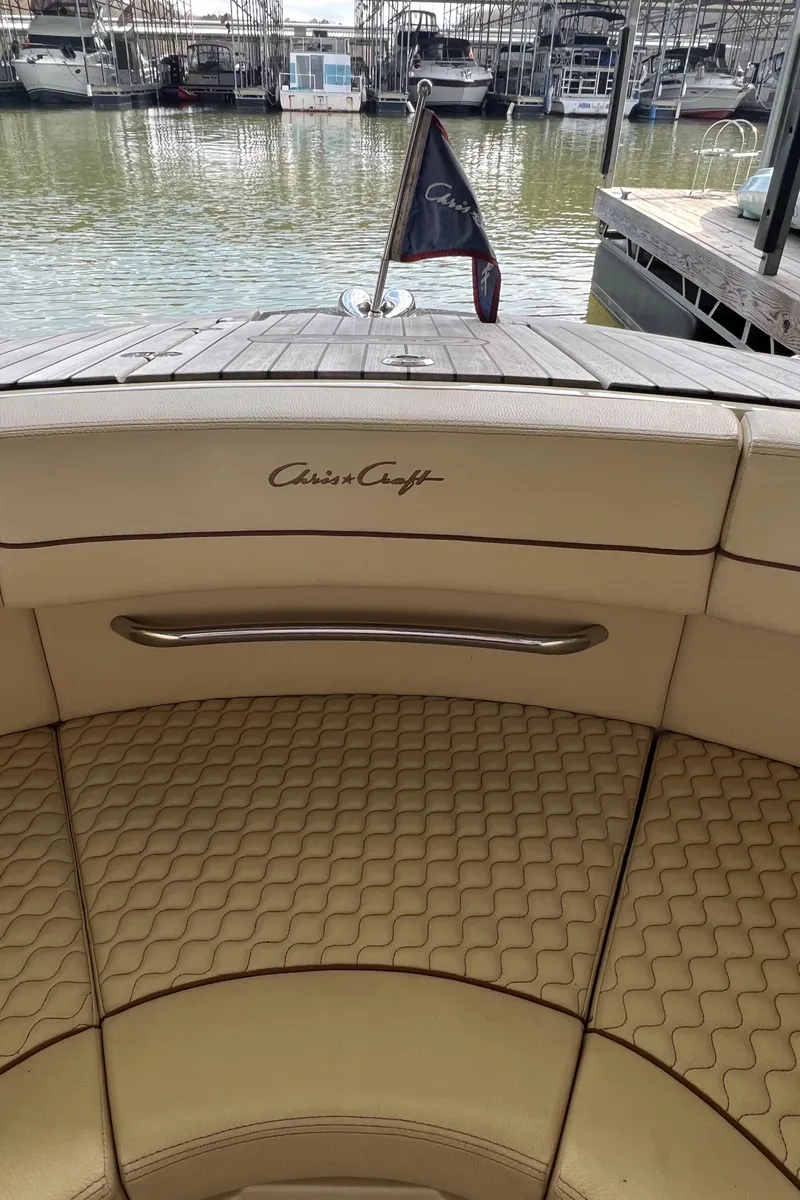 Slide: The Image of 2020 Chris-Craft Launch 31 GT boat interior with logo and docked at marina. - 47