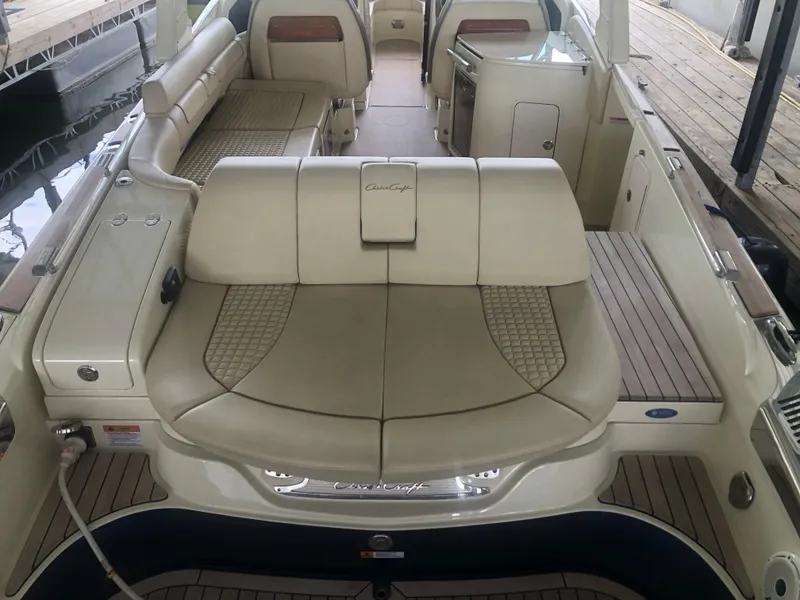 Slide: The Image of 2020 Chris-Craft Launch 31 GT boat interior with beige leather seating and wooden deck. - 49