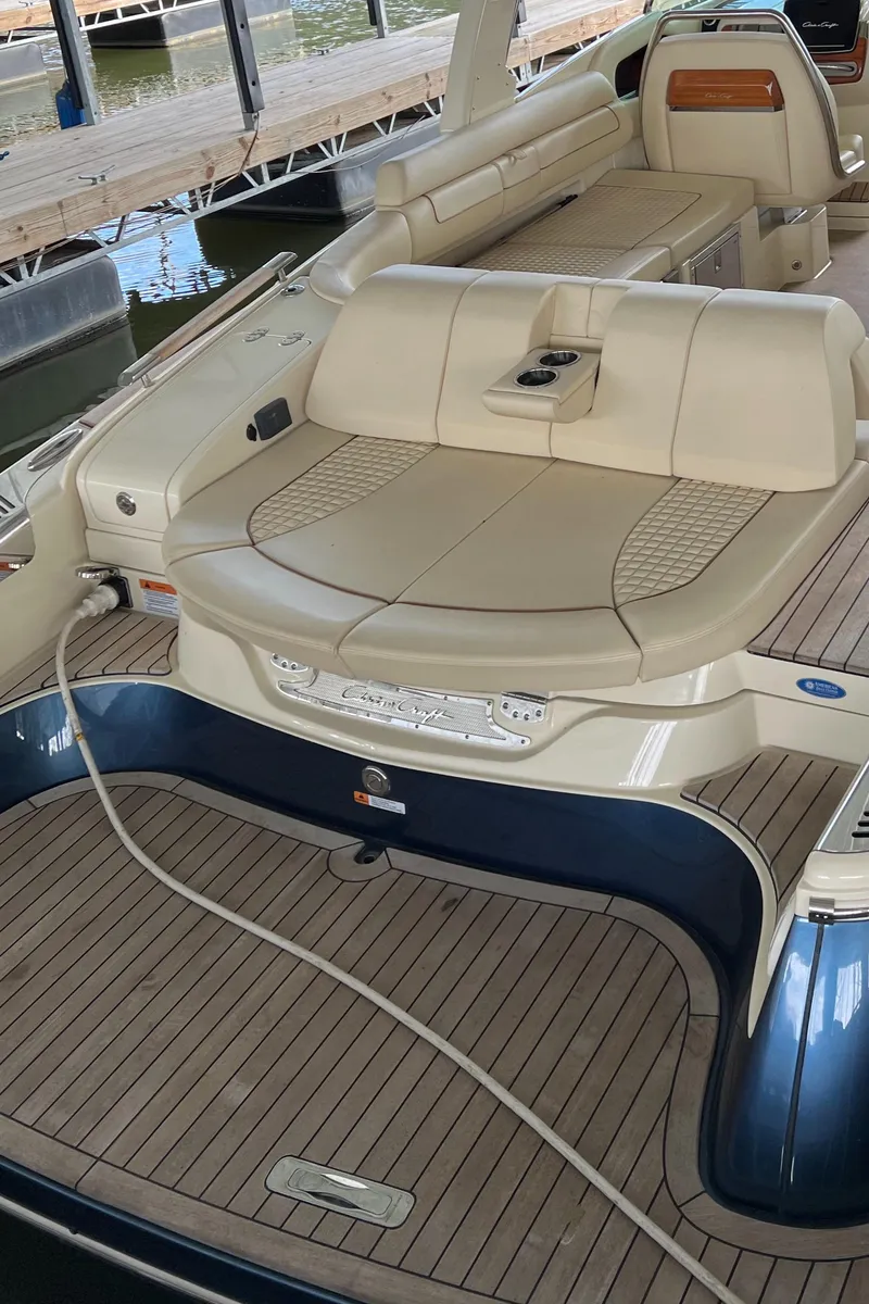 Slide: The Image of 2020 Chris-Craft Launch 31 GT luxury boat interior with beige seating and wooden deck. - 9