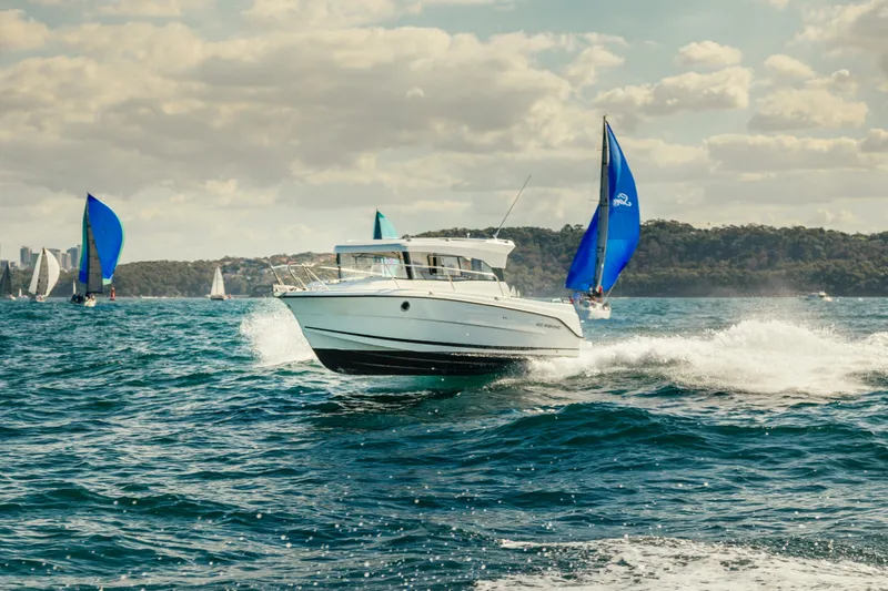 Slide: The Image of Parker 800 Weekend 2021 model boat cruising on a sunny day with sailboats in the background. - 13